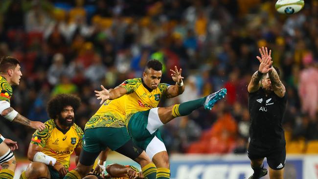 Will Genia kicks ahead as Rieko Ioane attempts to charge down.