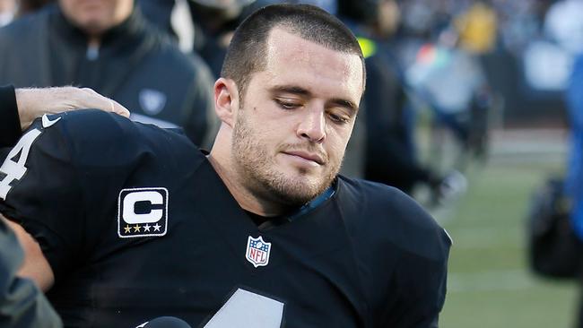 Derek Carr #4 of the Oakland Raiders is attended to by medical staff.