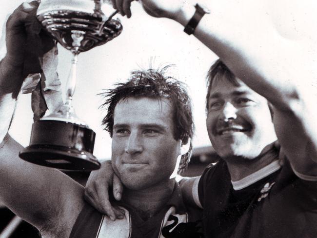 Edithvale-Aspendale captain Brett Wright and coach Kenny Little lift the 1987 premiership cup.