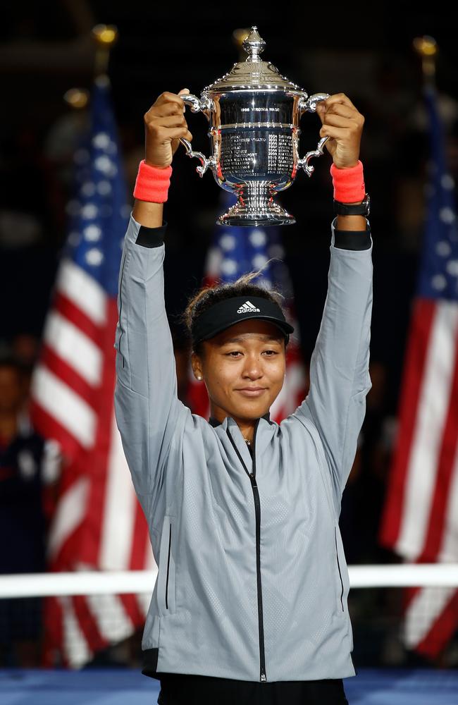 Naomi Osaka holds aloft the US Open winner’s trophy. Julian Finney/Getty Images/AFP