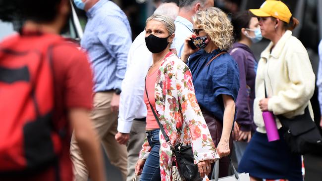 People walk through the streets of Brisbane with masks on. Picture: NCA NewsWire / Dan Peled