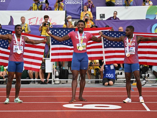 Silver medallist USA's Marvin Bracy (L), gold medallist USA's Fred Kerley (C) and USA's Trayvon Bromell (R) celebrate after the men's 100m final during the World Athletics Championships at Hayward Field in Eugene, Oregon on July 16, 2022. (Photo by ANDREJ ISAKOVIC / AFP)