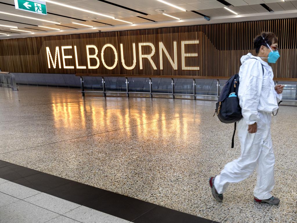 Some overseas travellers were taking no chances as they arrived in Melbourne. Picture: David Geraghty