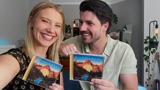 Sydney musicians Jess and Matt with CD copies of their album Wildflowers. Pic: Supplied