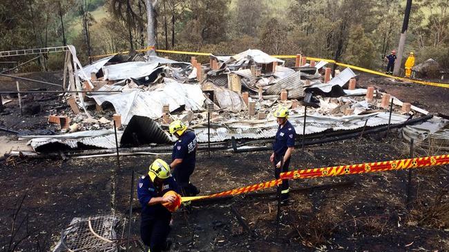 Fire crews at the remains of a house at Pappinbarra, west of Wauchope. Picture: Nathan Edwards
