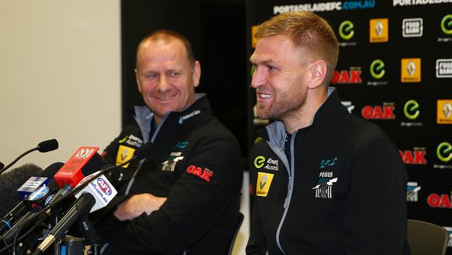 Hinkley watches on as Kane jokes while announcing his retirement at a press conference. Photo: Sarah Reed