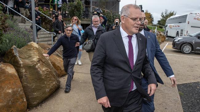 Former Solomons high commissioner Trevor Sofield, front left, is physically stopped from talking to Scott Morrison. Picture: Jason Edwards