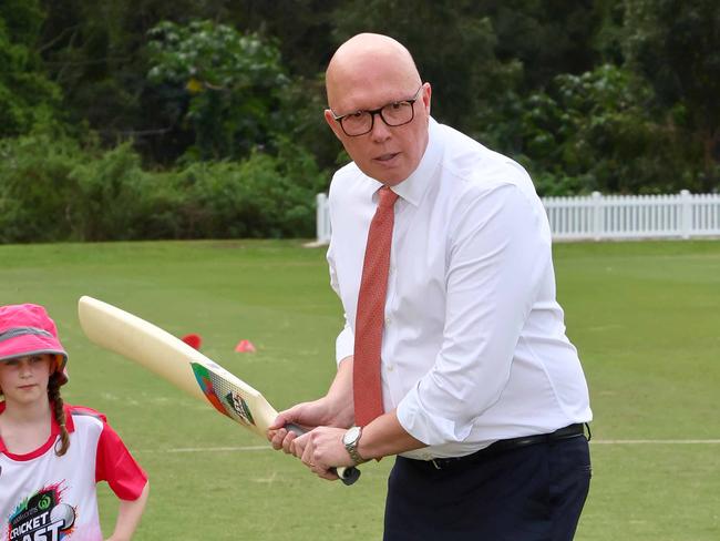 BRISBANE, AUSTRALIA - NewsWire Photos SEPTEMBER 19, 2024: The Leader of the Opposition Peter Dutton bats as Olivia, 7, looks on during a visit to the Valley District cricket club in Ashgrove. Picture: NewsWire/Tertius Pickard