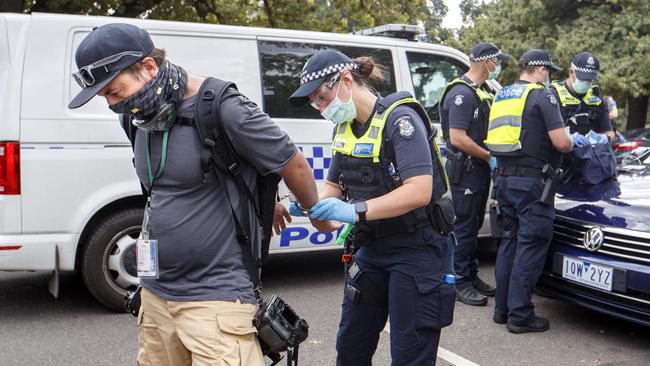 Herald Sun photographer Jake Nowakowski being handcuffed by police. Picture: NCA NewsWire