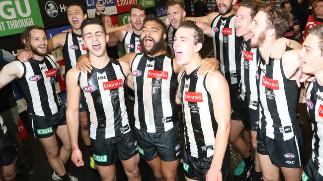 Collingwood players sing the club song after beating Melbourne. Picture: Alex Coppel