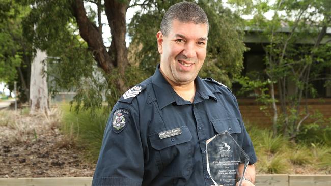 Snr Sgt Mark Van Rooyen with his award. Picture: Hamish Blair