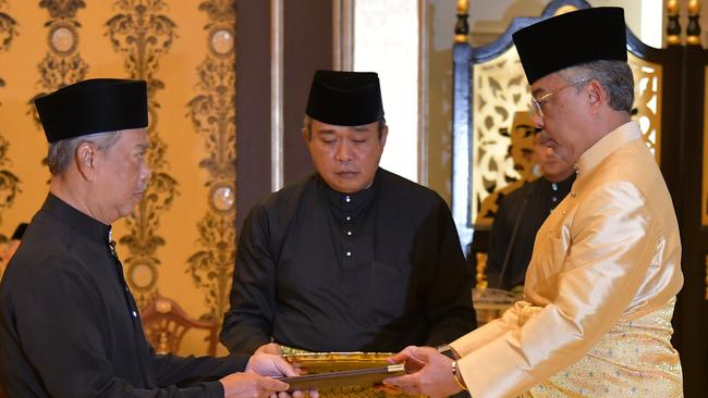 Muhyiddin Yassin, left, receives his mandate from King Abdullah Sultan Ahmad Shah in March. Picture: AFP