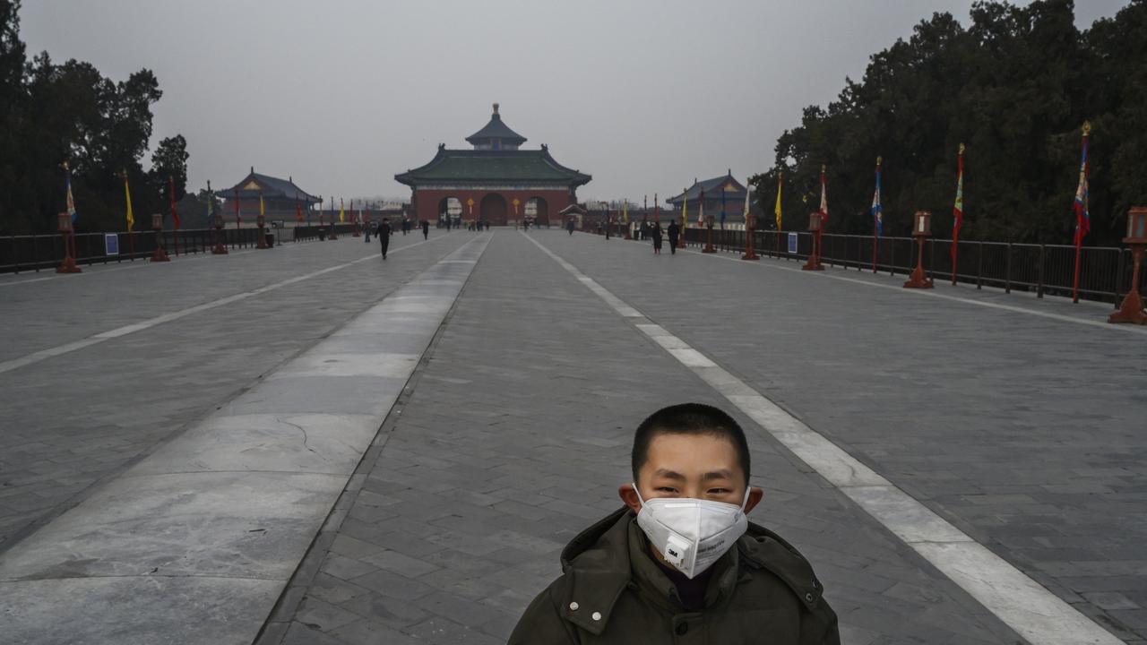 A Chinese visitor wear a protective mask as he tours the nearly empty grounds of the Temple of Heaven, which remained open during the Chinese New Year and Spring Festival holiday on January 27, 2020 in Beijing, China. Picture: Kevin Frayer/Getty Images