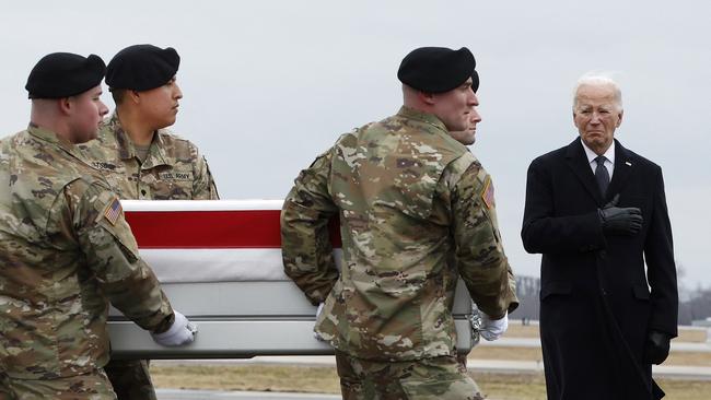 President Joe Biden salutes as a US Army carry team moves a flag-draped transfer case containing the remains of Army Sgt. Kennedy Sanders.