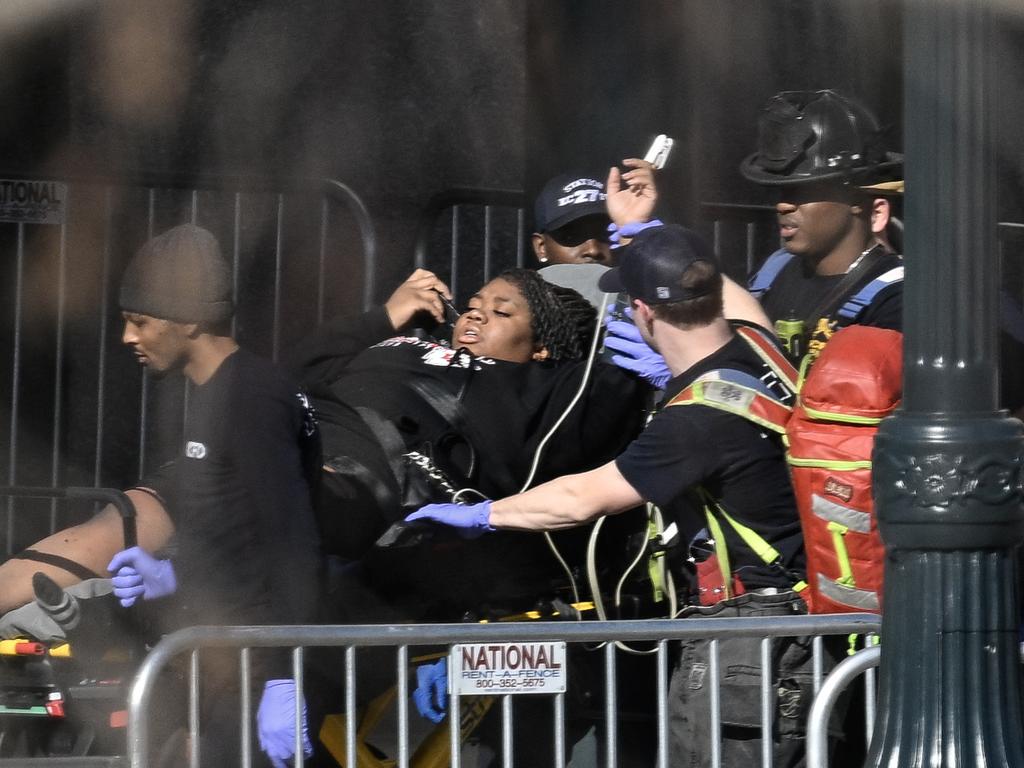 First responders tend to an injured person as they bring her out of Union Station near the Kansas City Chiefs' Super Bowl LVIII victory parade. Picture: AFP