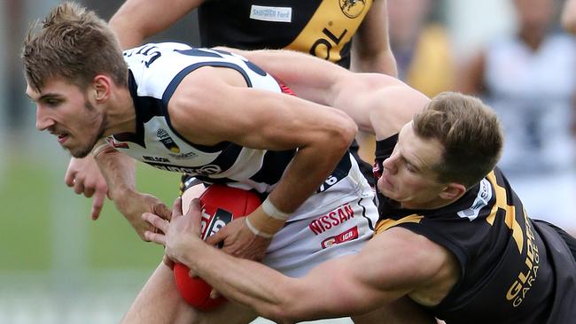 South's Tyson Brown is tackled by Glenelg's Dylan Reinbrecht. Picture: Dylan Coker