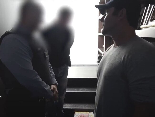 Mim Salvato being questioned by police after a bag containing white powder was found on a book shelf inside John Ibrahim’s Dover Heights mansion.