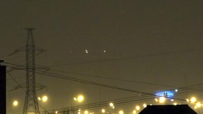 CREDIT: CEN/Australscope ONLINE USE ONLY Pic shows: The UFOs flying in unison over Moscow. Astonishing video footage of what looks like a cluster of UFOs flying in unison over Moscow has been declared authentic by experts. The film - shot in Russia's capital at the end of last month - shows four unidentified lights hovering and swooping above the city in what looks like synchronised flying.