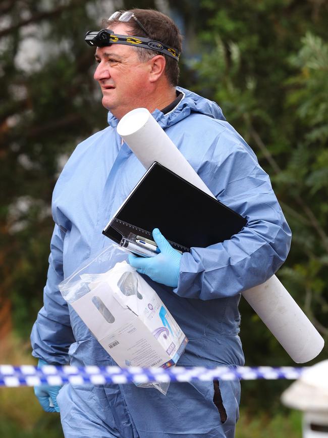 Police remove evidence from a house on Patullos Rd, Lara where a man was killed. Picture: Alison Wynd