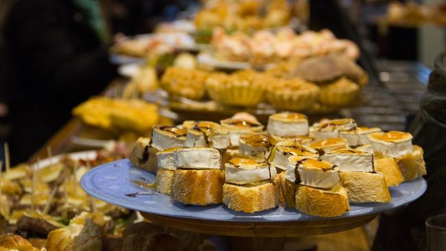 Traditional pintxos plates with goat cheese and jam on a slice of bread.