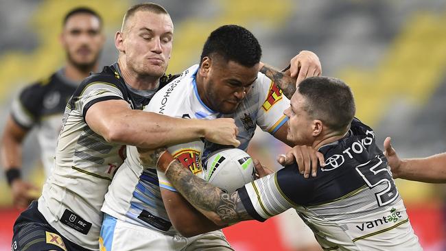 TOWNSVILLE, AUSTRALIA - MAY 29: Sam Lisone of the Titans is tackled by Coen Hess and Ben Hampton of the Cowboys during the round three NRL match between the North Queensland Cowboys and the Gold Coast Titans at QCB Stadium on May 29, 2020 in Townsville, Australia. (Photo by Ian Hitchcock/Getty Images)