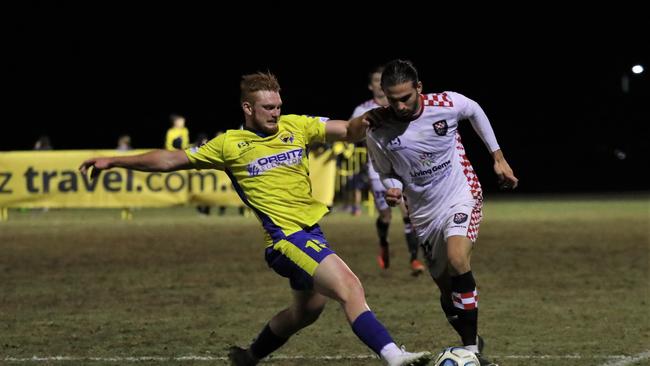 Gold Coast United and Gold Coast Knights played out a 2-2 draw in Round 22 of the NPL Qld competition at Coplick Family Sports Park, tallebudgera, on Tuesday, July 2, 2019. Pictured is United's Dean Wernerson (left) and Knights player Jarrod Kyle. Picture credit: Sportspics.