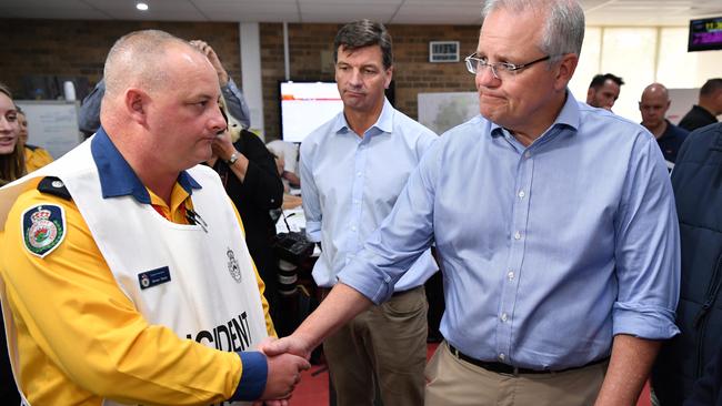 Prime Minister Scott Morrison meets a Rural Fire Service employee at the Wollondilly Emergency Control Centre. Picture: AAP Image/Joel Carrett