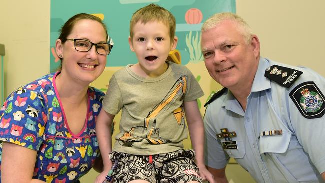 Paediatric oncology clinical nurse Jessica Loveday and Townsville Chief Superintendent Craig Hanlon with patient Blade Cook, 6, who is one of the children loving new police-funded artwork in the wards.