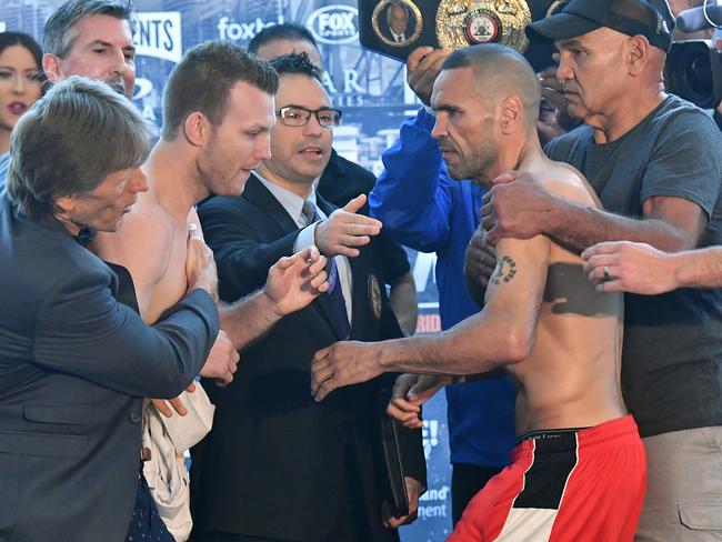 Jeff Horn’s trainer Glenn Rushton steps in (left) as does Anthony Mundine’s trainer Tony Mundine. Picture: AAP