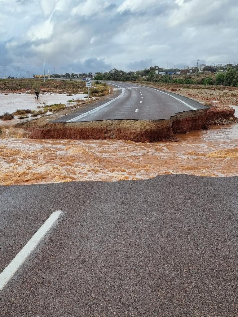 The road north to Woomera and Roxby Downs was cut off. This was the dramatic scene from Pimba, 480km north of Adelaide. On Tuesday, road crews were working on its repair. Picture: Spud’s Roadhouse.