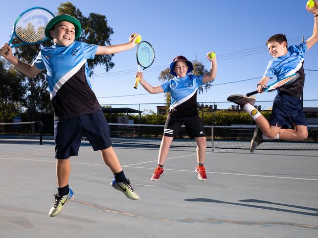 Hunter Copeland, 12, Sebastian Gardiner, 11, and Fraser Russell, 11, are stoked to be allowed back on the tennis court. Picture: EMMA MURRAY