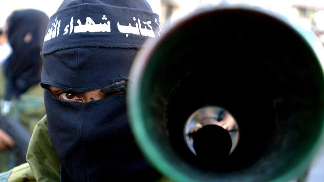 A Palestinian militant from the Al-Aqsa Martyrs Brigades carries a home-made rocket launcher during a rally in Gaza City.