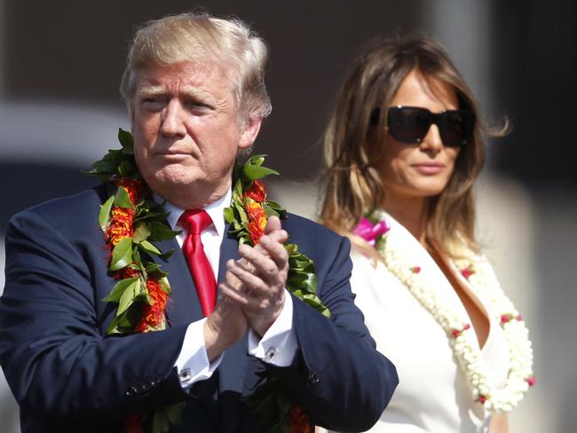 Adorned with lei, President Donald Trump walks with first lady Melania Trump to meet servicemen, at Joint Base Pearl Harbor Hickam in Honolulu as he flies to Asia. Picture: AP