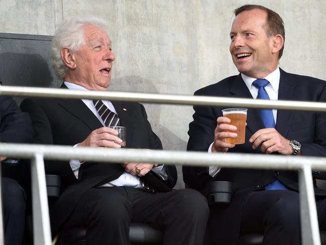 Down time: Tony Abbott (right) speaks with Football Federation of Australia Chairman Frank Lowy before Australia's opening football match against Kuwait in the AFC Asian Cup in Melbourne on January 9. Picture: AFP/William West