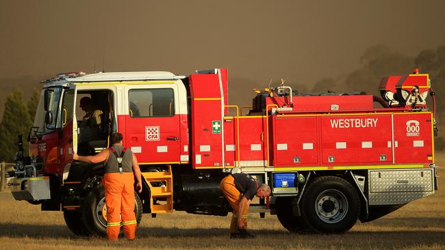 A fire crew at their truck amid battling bushfires Picture: Mark Stewart