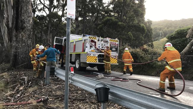 Firefighters and residents control a burn at Coal Point on Bruny Island. Picture: EDDIE SAFARIK