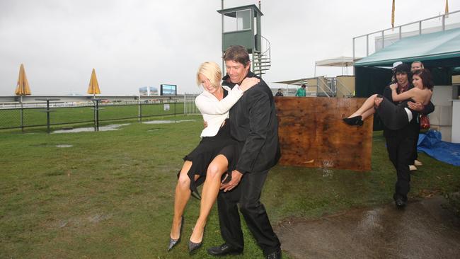 Mark Atkinson puts his wife Sandra down to a drier spot after carrying her during the 2008 event. Picture: Nicholas Falconer