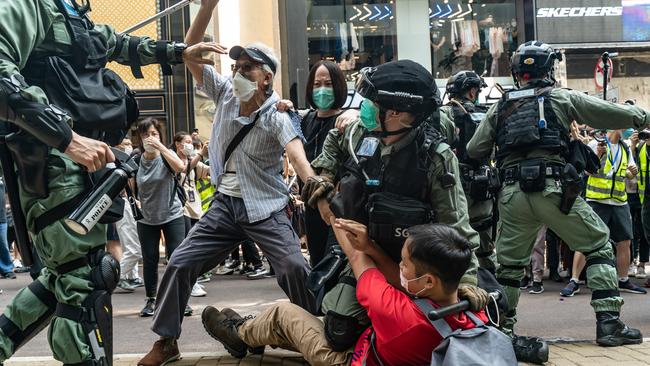 Pro-democracy supporters scuffle with riot police during an detention at a rally in Causeway Bay district on May 27. Picture: AFP