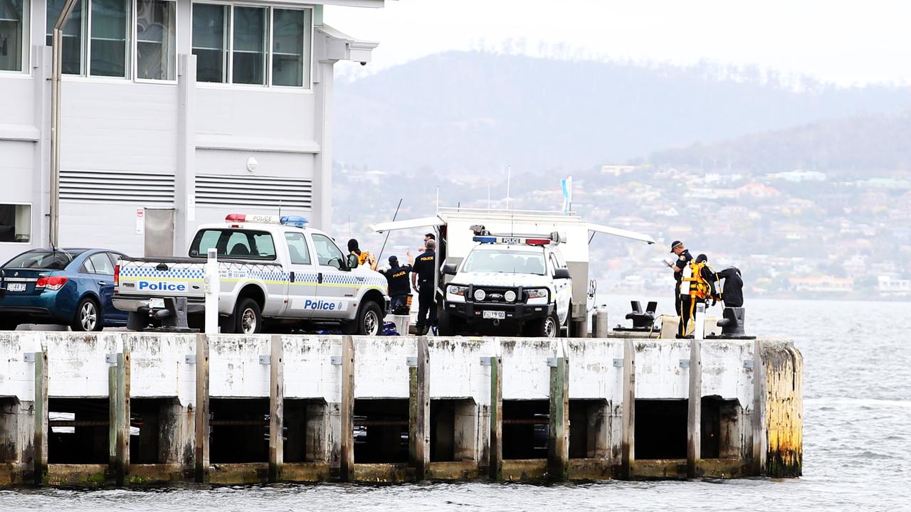 Tasmania Police divers at the end of Elizabeth Street Pier after the body of Jarrod Davies was found. Picture: Zak Simmonds