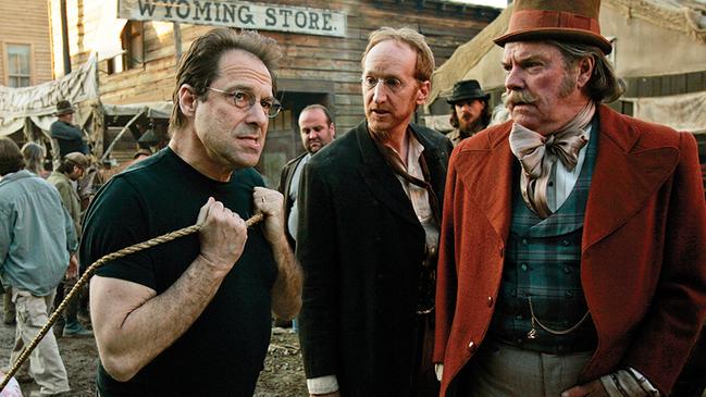 David Milch, left, creator of the HBO series "Deadwood," demonstrates how actor Larry Cedar, center, should pull a cart on Deadwood's main street as actor Peter Jason watches during filming in February 2005, in Santa Clarita, Califoniia. Picture: vork Djansezian