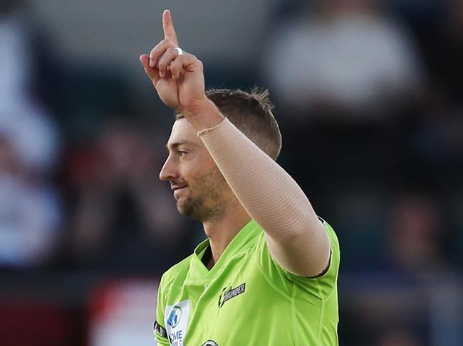 CANBERRA, AUSTRALIA - DECEMBER 14: Daniel Sams of the Thunder  celebrates after claiming the wicket of Sam Heazlett of the Heat during the Big Bash League match between the Sydney Thunder and the Brisbane Heat at Manuka Oval, on December 14, 2020, in Canberra, Australia. (Photo by Brendon Thorne/Getty Images)