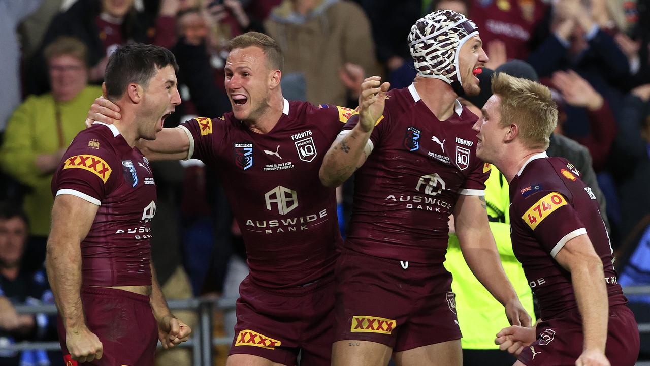 Ben Hunt celebrates with his teammates after scoring the match-sealing try for the Maroons. Picture: Adam Head