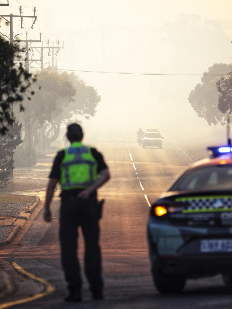 A police officer blocks a road off as the fire heads towards Port Lincoln. Picture: Robert Lang