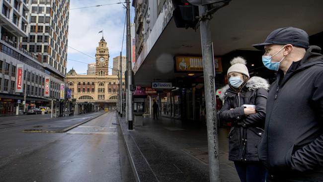 A couple walking down a deserted Elizabeth St in Melbourne CBD. Picture: NCA NewsWire/David Geraghty