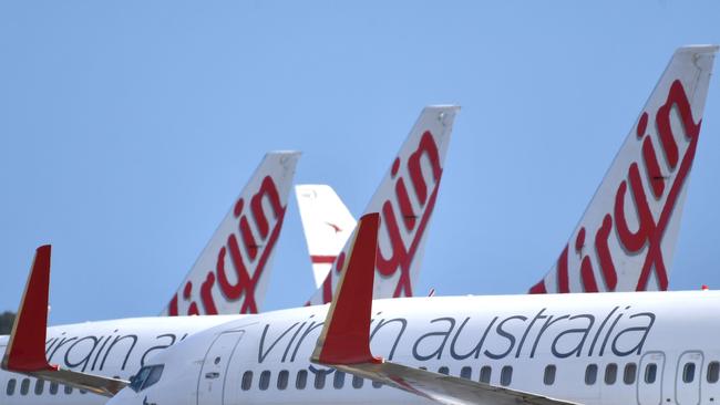 Virgin Australia planes have been parked on the tarmac as COVID-19 thwarts travel plans. (AAP Image/David Mariuz)