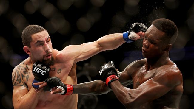 HOUSTON, TEXAS - FEBRUARY 12: Robert Whittaker of Australia punches Israel Adesanya of Nigeria in their middleweight championship fight during UFC 271 at Toyota Center on February 12, 2022 in Houston, Texas. (Photo by Carmen Mandato/Getty Images) ***BESTPIX***