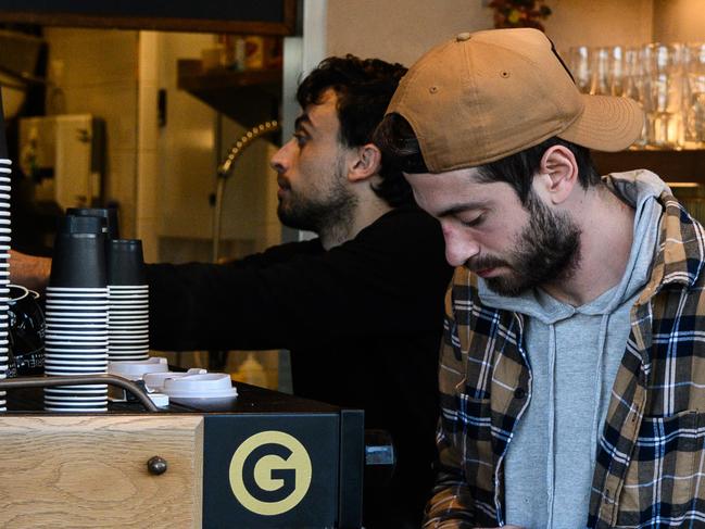 A barista working at a cafe near Bondi Beach in Sydney, Saturday, June 6, 2020. Coronavirus restrictions are slowly being eased across Australia with states and territories at different stages on the roadmap to reopen the nation. (AAP Image/James Gourley) NO ARCHIVING