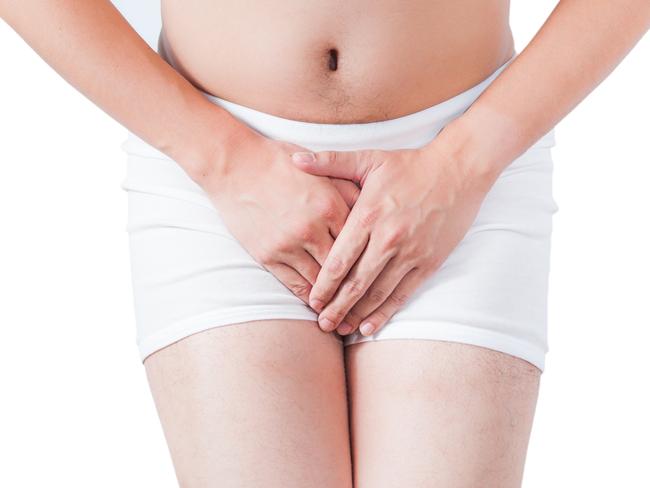 close up of shy man use hand to cover penis on white boxer underware isolate on white background