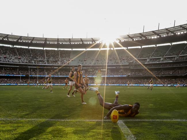 Mabior Chol dives for the ballas the sun sets at the MCG. Picture: Darrian Traynor/Getty Images.