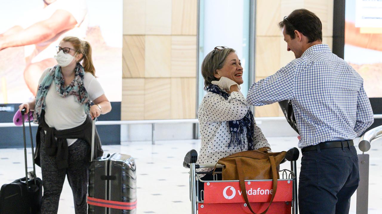 Two people greet each other with an elbow bump in the arrivals hall at Sydney International Airport on Friday. Picture: James Gourley/AAP